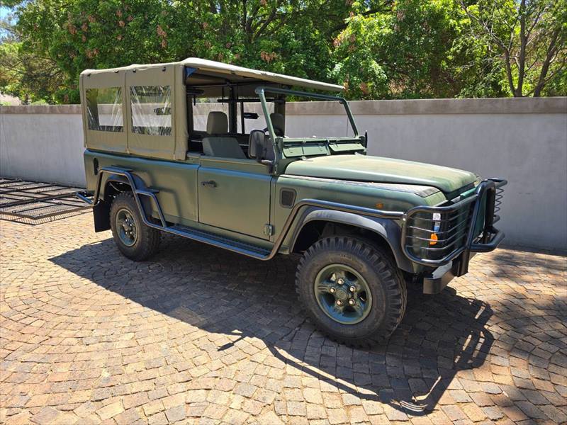 Olive Defender with a front bull bar