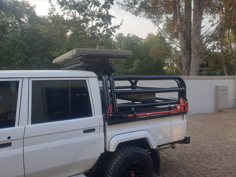 White Land Cruiser 79 with cattle frame and roof platform